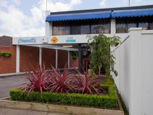a building with a bunch of plants in front of it at Connells Motel & Serviced Apartments in Traralgon