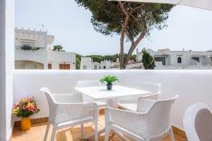 a white table and chairs on a balcony with a view at White suites 3 in Cala d´Or