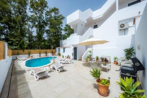 a villa with a swimming pool and a patio at White suites 3 in Cala d´Or