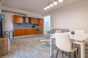 a kitchen and living room with a white table and chairs at Thomas' House in Alghero