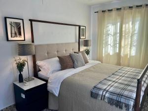 a bedroom with a large bed and a window at El Escondrijo Ibiza in San Antonio +26 photos