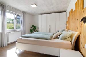 a bedroom with a large bed in a room with a window at Fewo Fuchs in Salem