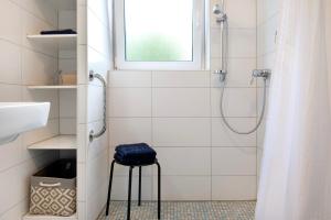 a bathroom with a shower and a stool with a window at Fewo Fuchs in Salem +22 photos