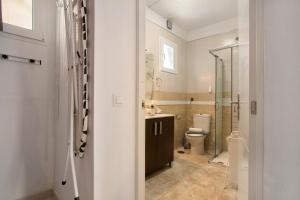 a bathroom with a toilet and a glass shower at Chez Martine Tenerife in Granadilla de Abona +17 photos