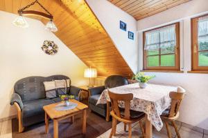 a living room with a table and chairs at Vogtshof in Bad Rippoldsau-Schapbach