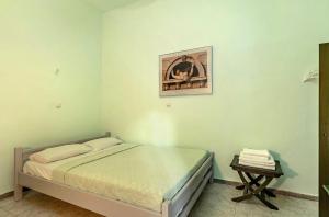 a bedroom with a bed with a picture on the wall at Old Boat double studio 2 in Nikiana