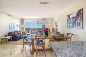 a living room with a table and chairs at Astonishing view modern apartment in Sitio de Calahonda