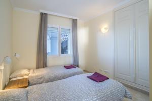 a bedroom with two beds and a window at Astonishing view modern apartment in Sitio de Calahonda +22 photos