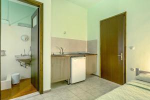 a small kitchen with a sink and a refrigerator at Old Boat double studio 2 in Nikiana +14 photos