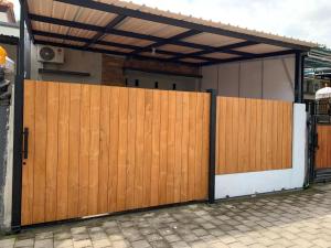 a wooden gate in front of a house at SS house in Tabanan