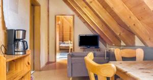 a living room with a couch and a tv at Ferienwohnung Pfisterhof in Kirchzarten