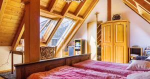 a bedroom with a bed and a large window at Ferienwohnung Pfisterhof in Kirchzarten