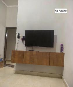 a flat screen tv sitting on top of a wall at SS house in Tabanan