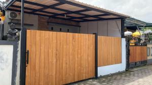a wooden gate in front of a building at SS house in Tabanan