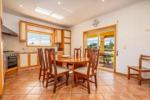 a kitchen with a wooden table and chairs at Villa Alvor in Alvor