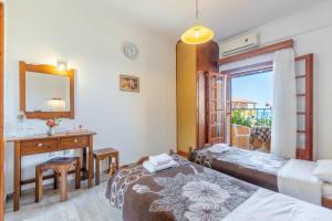 a bedroom with two beds and a desk and a mirror at Mires House Side First Floor 7 in Agios Gordios