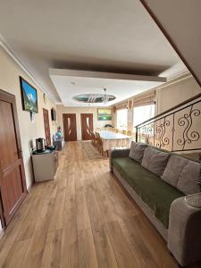 a living room with a couch and a bed at Tumar guest house, Kochkor in Kochkorka +11 photos