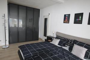 a bedroom with a blue bed and black cabinets at Haus Meereswelle in Büsum