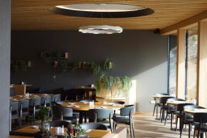 a dining room with wooden tables and chairs at Hotel Klugbauer in Sommereben