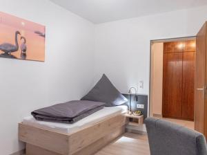 a bedroom with a bed with a picture of a bird at Comfort Apartment Buchhorn in Friedrichshafen