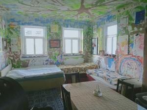 a room with two beds and graffiticovered walls at Ubytování v galerii in Zlatá Olešnice +6 photos