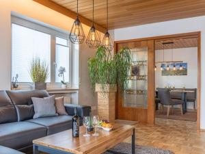 a living room with a couch and a table at Comfort Apartment Buchhorn in Friedrichshafen