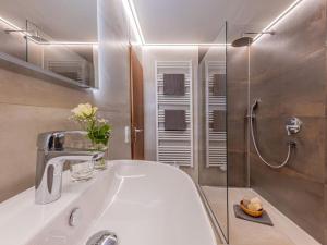 a bathroom with a sink and a shower at Comfort Apartment Buchhorn in Friedrichshafen +29 photos