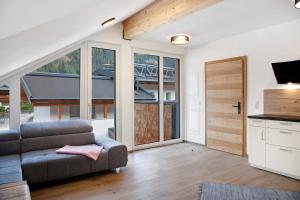 a living room with a couch and a large window at Apartement Bens Auszeit Top 5 in Umhausen