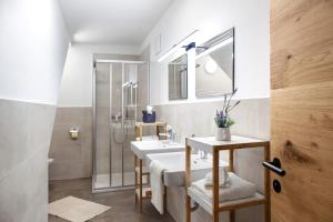 a bathroom with two sinks and a shower at Apartement Bens Auszeit Top 5 in Umhausen +13 photos