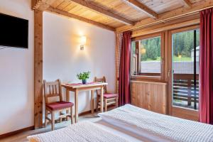 a bedroom with a desk and a table and chairs at Naturidyll Mitterbach in Rio Bianco +201 photos