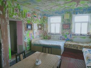 a room with a bed and a wall covered in graffiti at Ubytování v galerii in Zlatá Olešnice