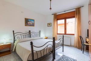 a bedroom with a bed and a window at Hotel Da Concetta a Jerzu in Jerzu