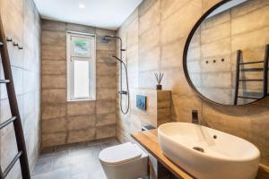 a bathroom with a sink and a mirror at Haus Waldberg in Unterschönau +17 photos