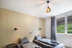 a bedroom with two beds and a window at Haus Waldberg in Unterschönau