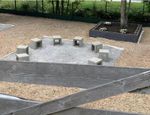 a park with a playground with a tree and benches at Haus Waldberg in Unterschönau