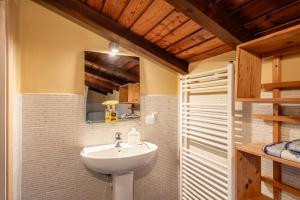 a bathroom with a sink and a mirror at Casale di Polly in Garfagnana in Minucciano