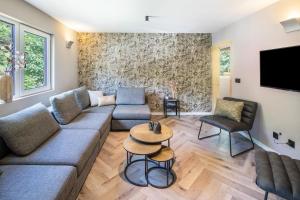a living room with a couch and a tv at Haus Waldberg in Unterschönau