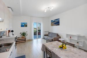 a kitchen and living room with a table and a couch at Casa Vacanza Anni' in Vico Equense +28 photos