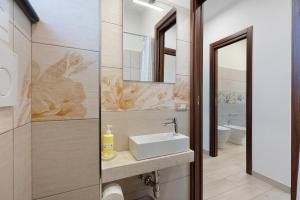 a bathroom with a sink and a mirror at Casa Vacanza Anni' in Vico Equense