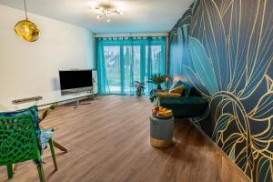 a living room with a couch and a tv at Hotz in Radolfzell am Bodensee