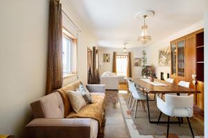 a living room with a couch and a table at Villa da Floresta in Arcos