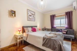 a bedroom with a large bed and a couch at Villa da Floresta in Arcos +23 photos