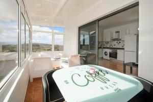 a kitchen and living room with a coca cola sign on a table at Apartamento Ye in Haría