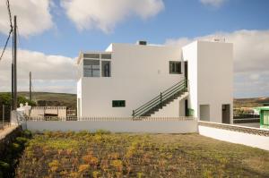 a white house on top of a hill at Apartamento Ye in Haría +17 photos