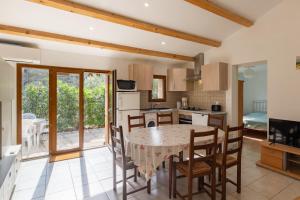 a kitchen and dining room with a table and chairs at Les Sources Gîte calabert in Chambonas