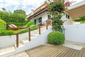 a house with a staircase in front of it at Casa de praia na costa da Galé in Melides