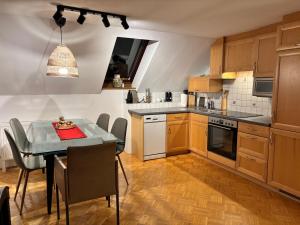 a kitchen with a table and a dining room at Mmapartment in Feistritz ob Bleiburg