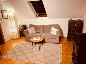 a living room with a couch and a table at Mmapartment in Feistritz ob Bleiburg