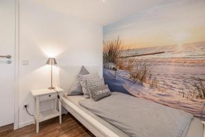 a bedroom with a wall mural of a beach at Ferienwohnung Doris in Viöl