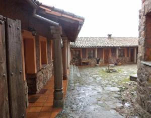 an outside view of a building with a courtyard at Mansió De La Plata in Peñacaballera